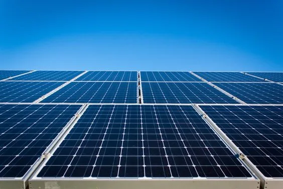 Rows of solar panels against a blue sky